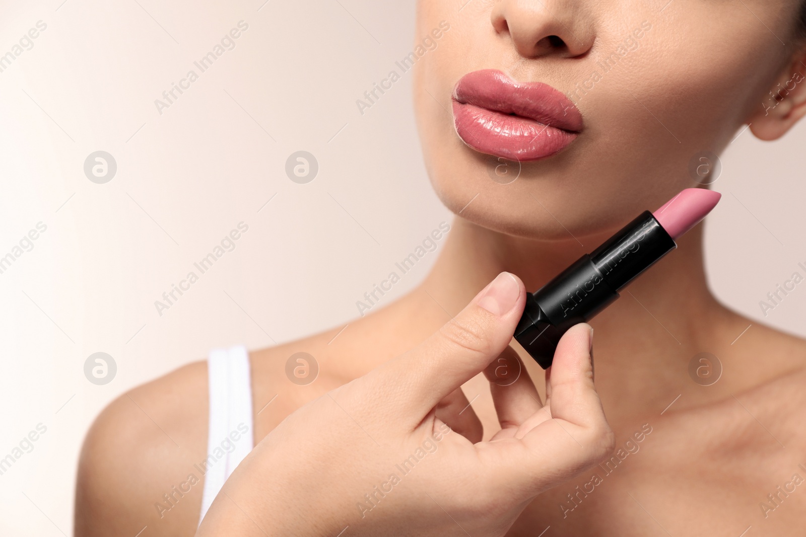 Photo of Woman with pink lipstick on light background, closeup