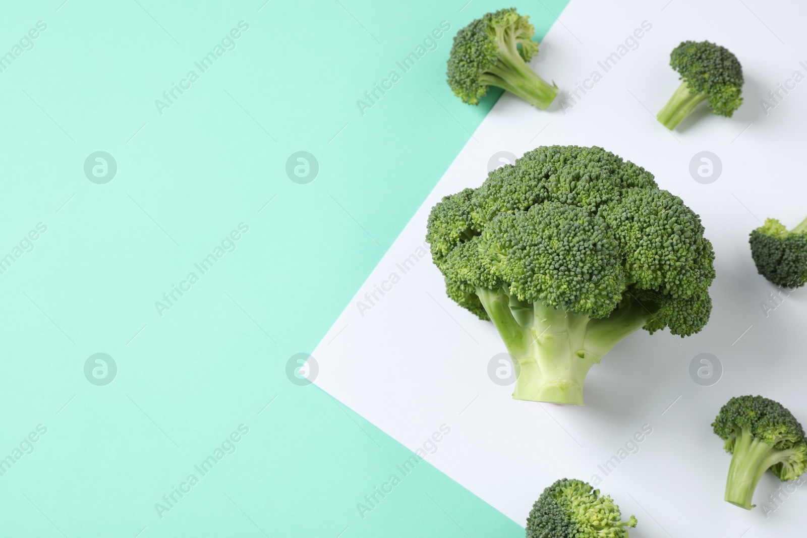 Photo of Fresh tasty broccoli on color background, flat lay