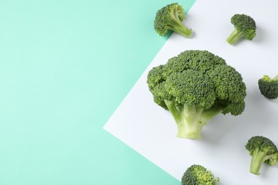 Fresh tasty broccoli on color background, flat lay