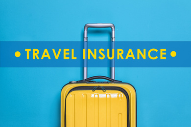 Image of Yellow suitcase and phrase TRAVEL INSURANCE on blue background