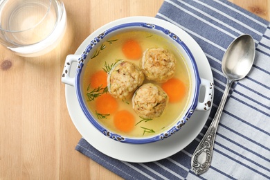 Flat lay composition with Jewish matzoh balls soup on wooden table