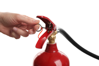 Woman using fire extinguisher on white background, closeup