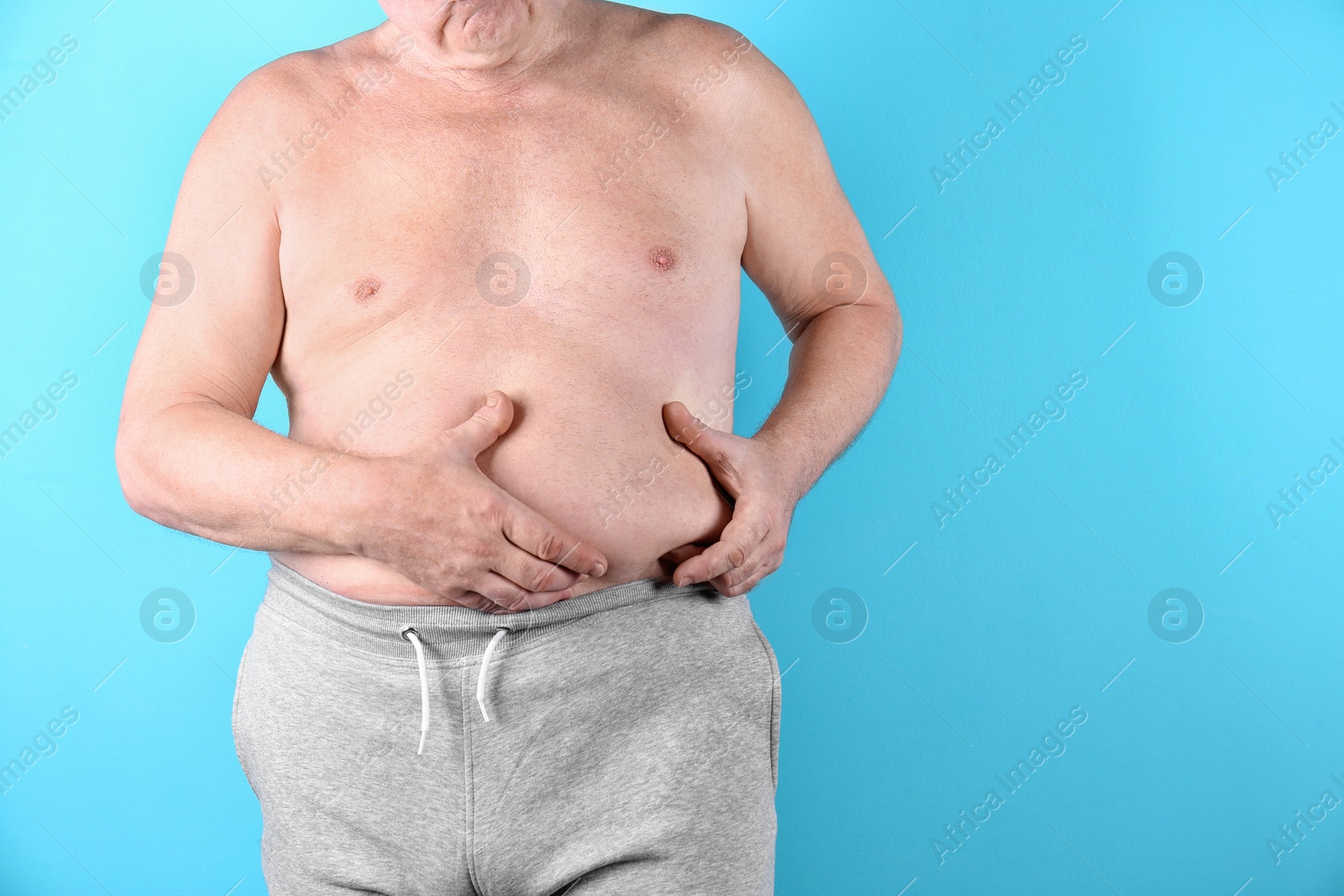 Photo of Fat senior man on color background, space for text. Weight loss
