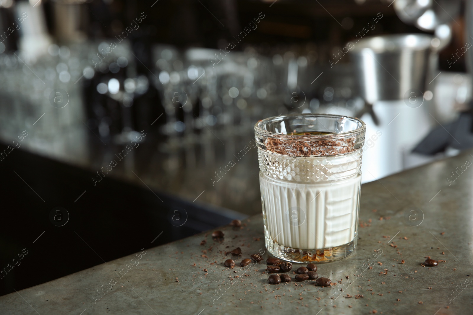 Photo of Fresh alcoholic White Russian cocktail on bar counter. Space for text