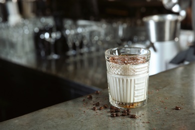 Photo of Fresh alcoholic White Russian cocktail on bar counter. Space for text