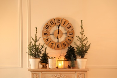 Small fir trees on mantelpiece indoors. Christmas interior design