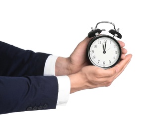 Photo of Businessman holding alarm clock on white background. Time concept