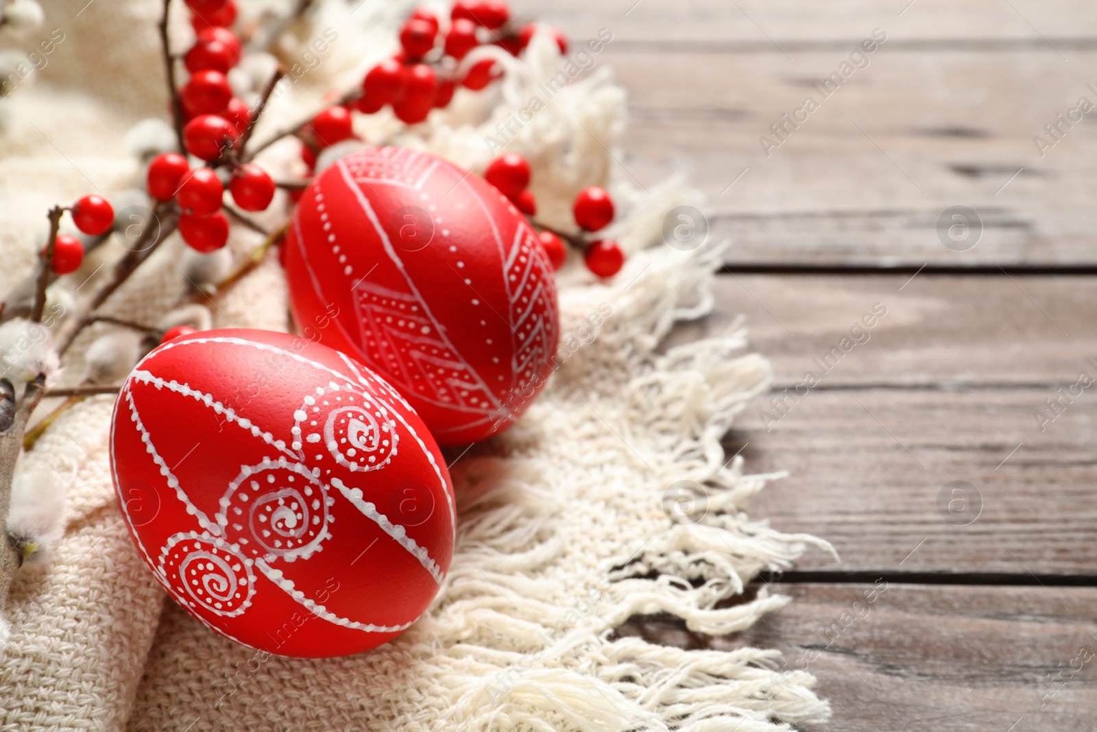 Photo of Red painted Easter eggs on wooden table, closeup. Space for text