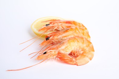 Photo of Delicious cooked shrimps and lemon isolated on white