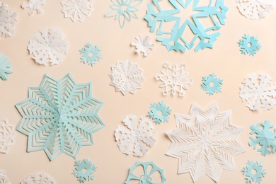 Many paper snowflakes on light background, flat lay
