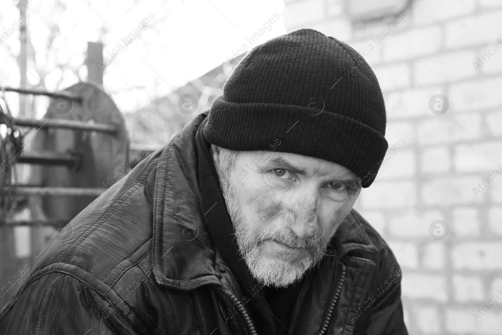 Photo of Portrait of poor homeless man with hat outdoors