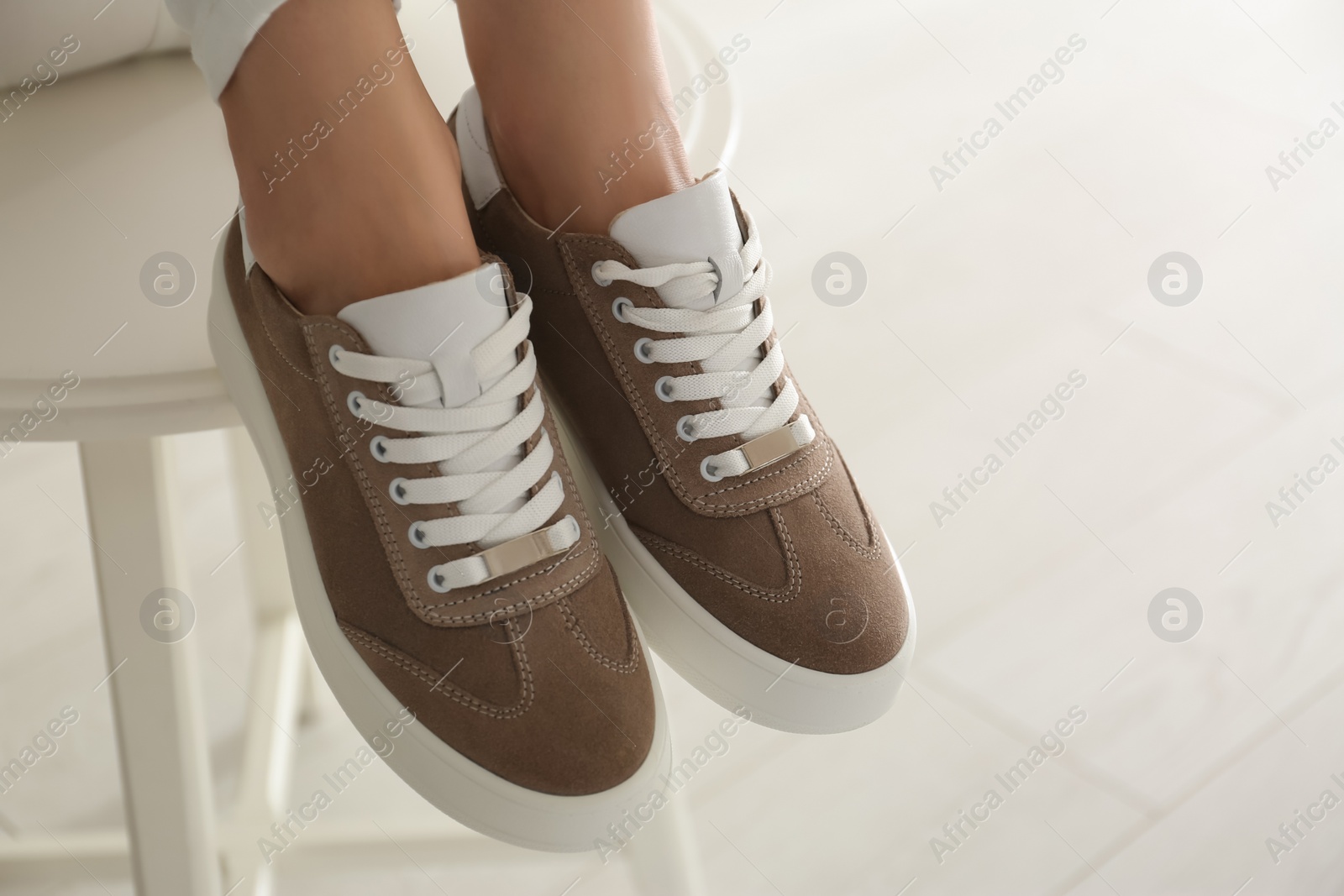 Photo of Woman wearing comfortable stylish shoes indoors, closeup