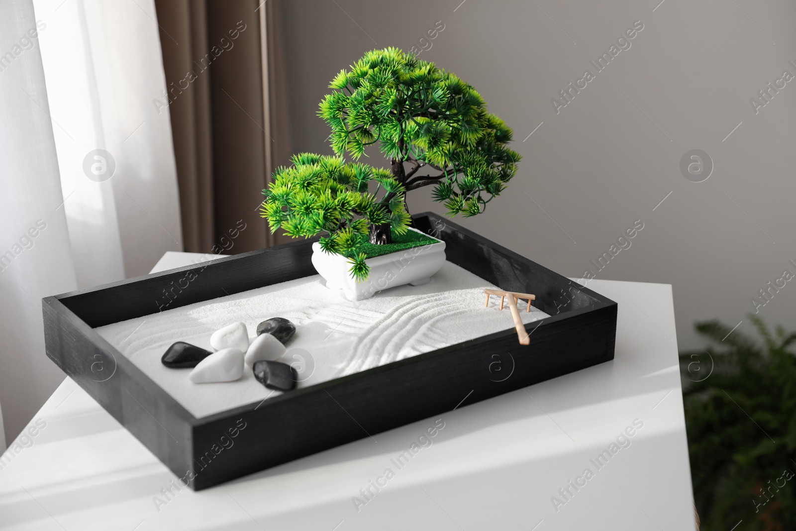 Photo of Beautiful miniature zen garden on white table indoors