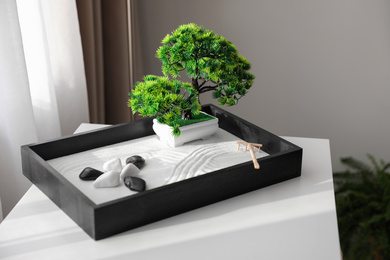 Photo of Beautiful miniature zen garden on white table indoors