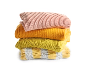 Photo of Stack of warm knitted clothes on white background