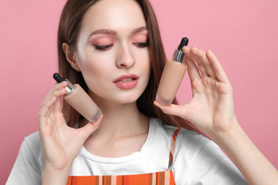 Beauty blogger with foundation on pink background