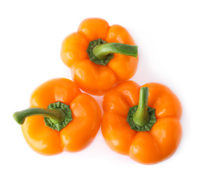 Photo of Ripe orange bell peppers isolated on white, top view