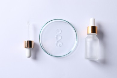 Petri dish with cosmetic serum, pipette and bottle on white background, flat lay