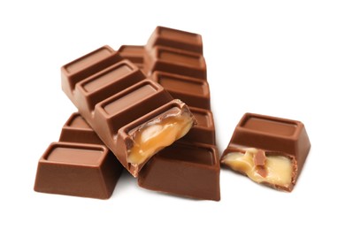 Photo of Tasty sweet chocolate bars on white table, closeup