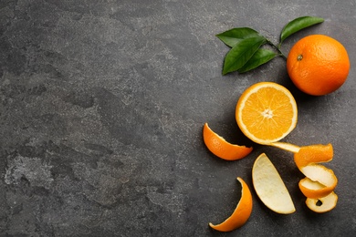 Dry orange fruits with peels on grey table, flat lay. Space for text