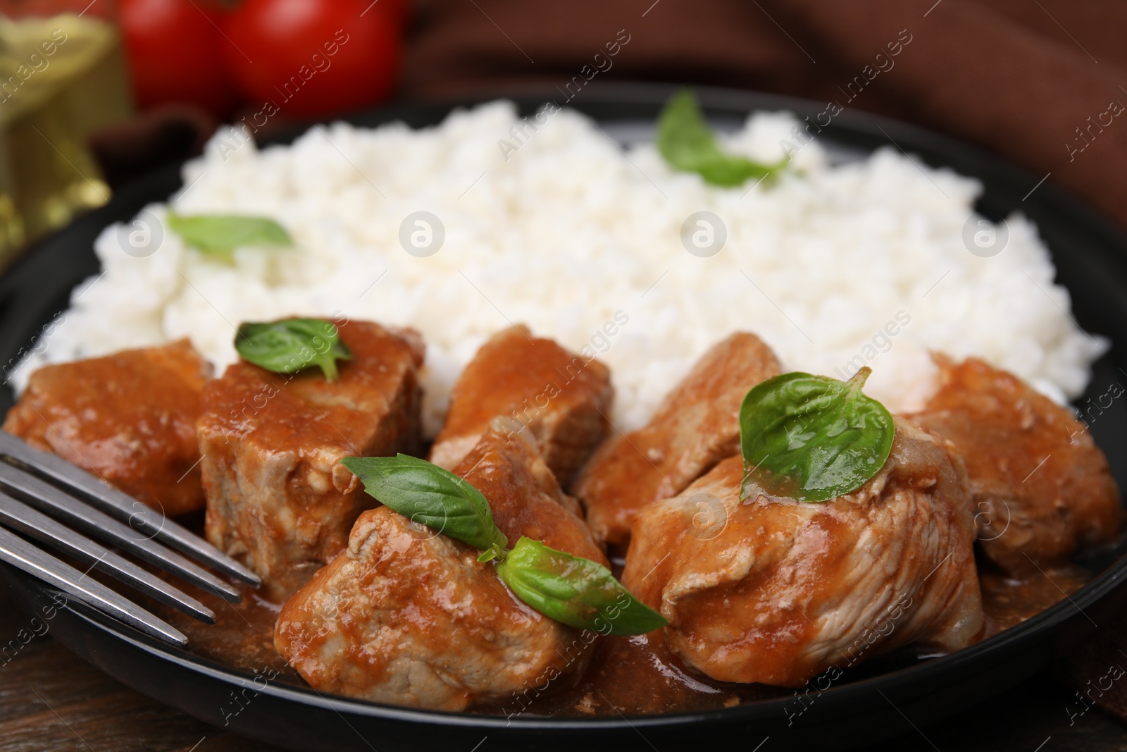 Photo of Delicious goulash served with rice on table, closeup