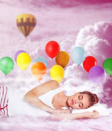 Image of Sweet dreams. Pink cloudy sky with bright air balloons around sleeping young woman