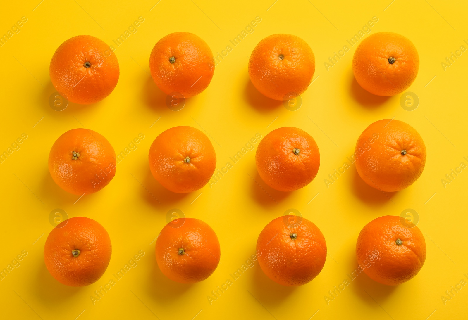 Photo of Fresh ripe oranges on yellow background, flat lay