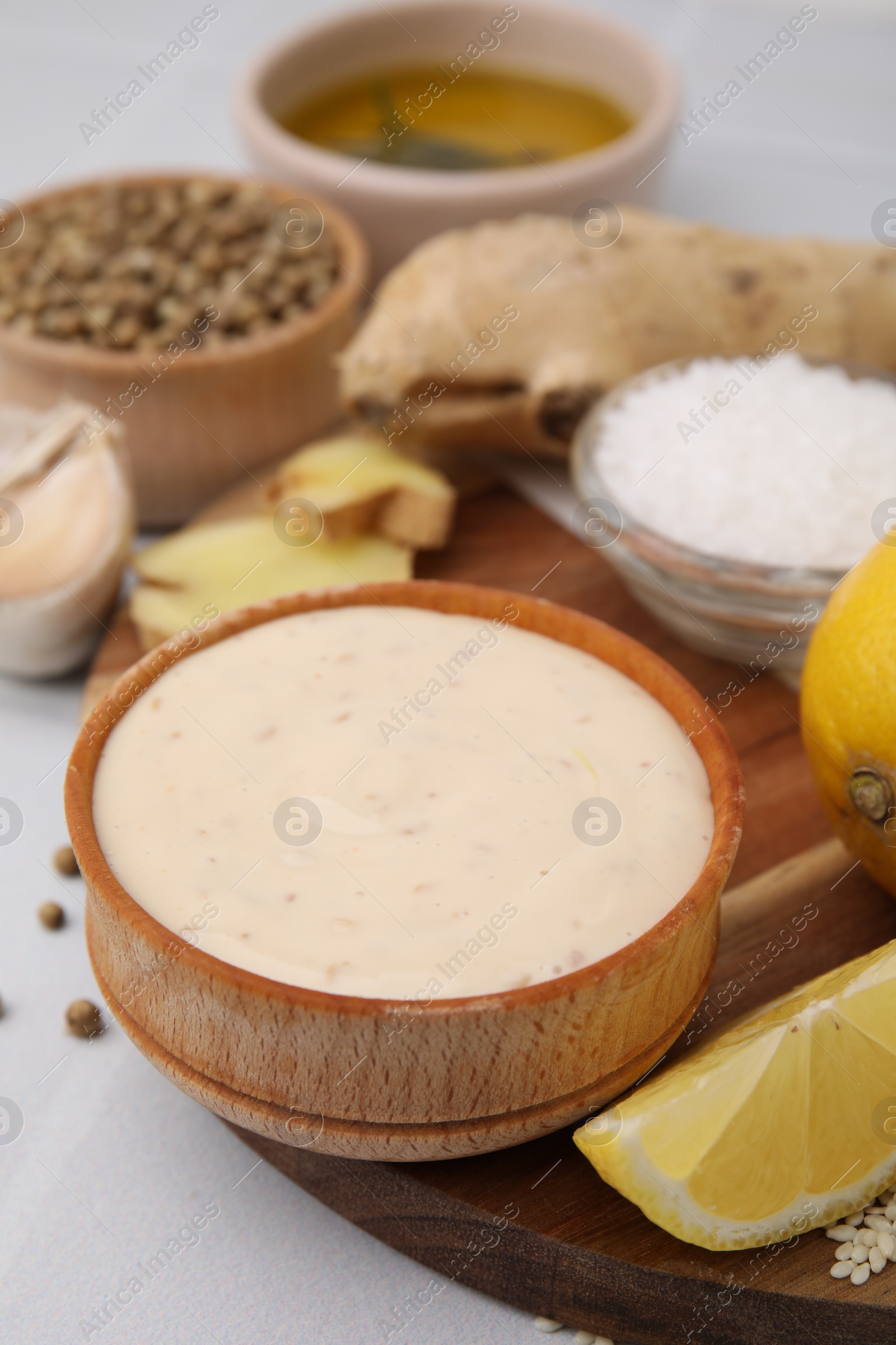 Photo of Fresh marinade and different ingredients on white table, closeup