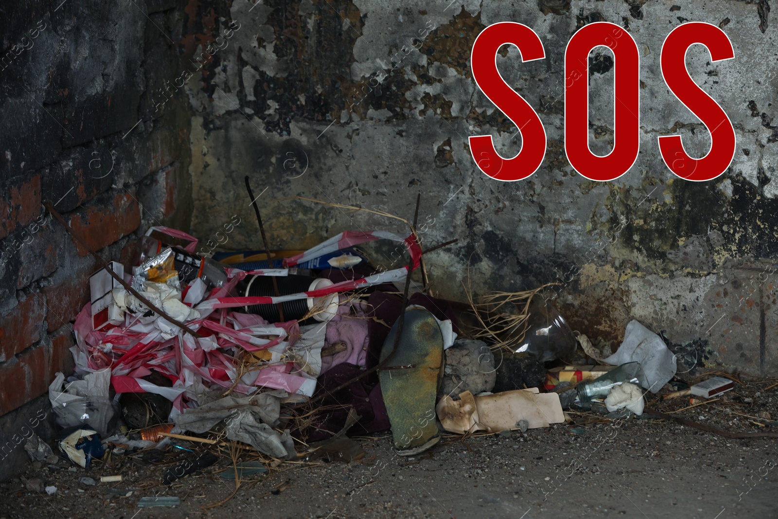 Image of Word SOS and garbage dump inside of old abandoned building