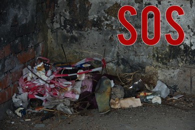 Image of Word SOS and garbage dump inside of old abandoned building
