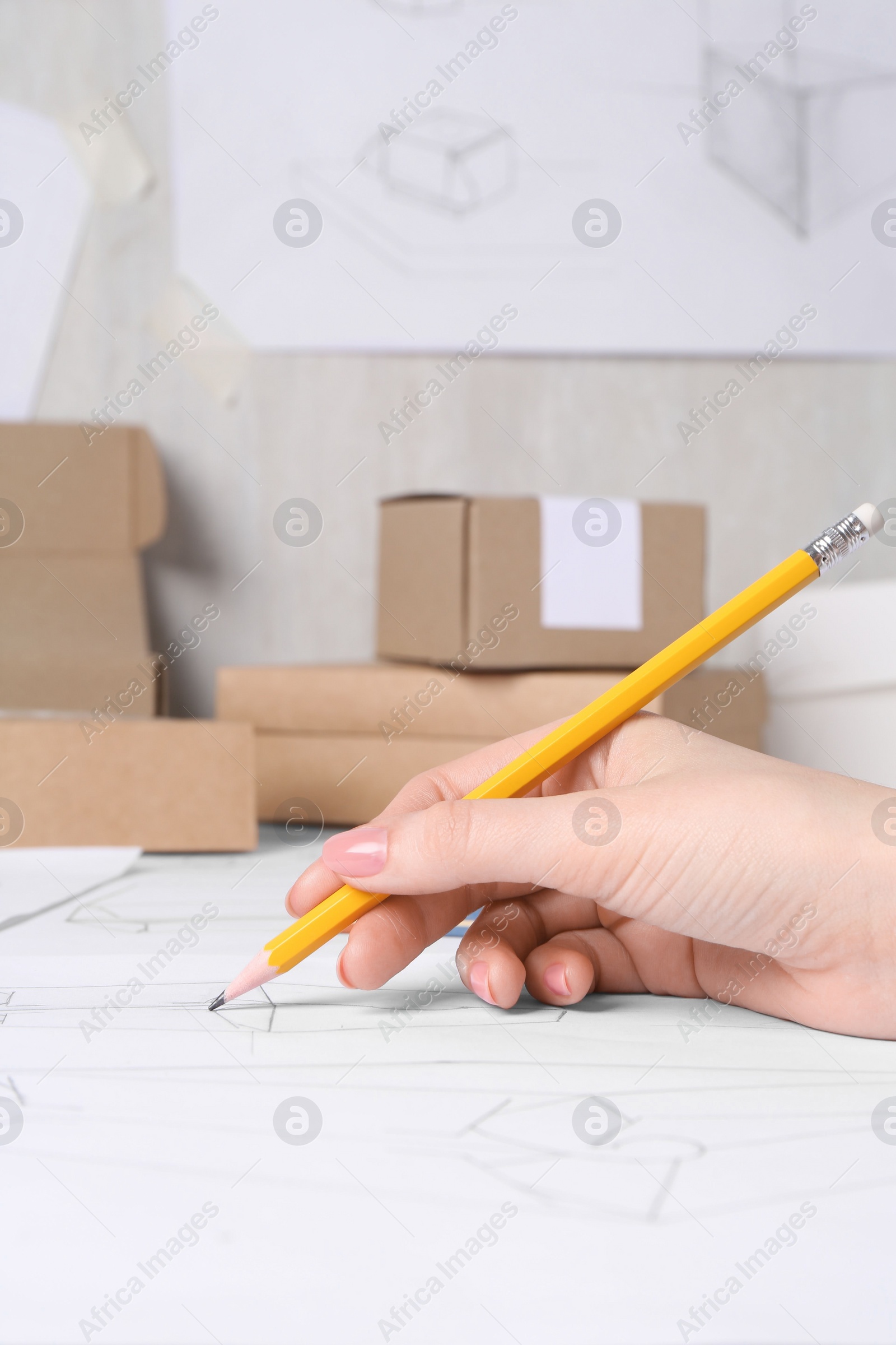 Photo of Woman creating packaging design at table, closeup