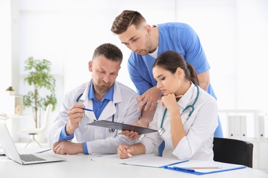 Photo of Group of doctors attending meeting in clinic. Cardiology conference