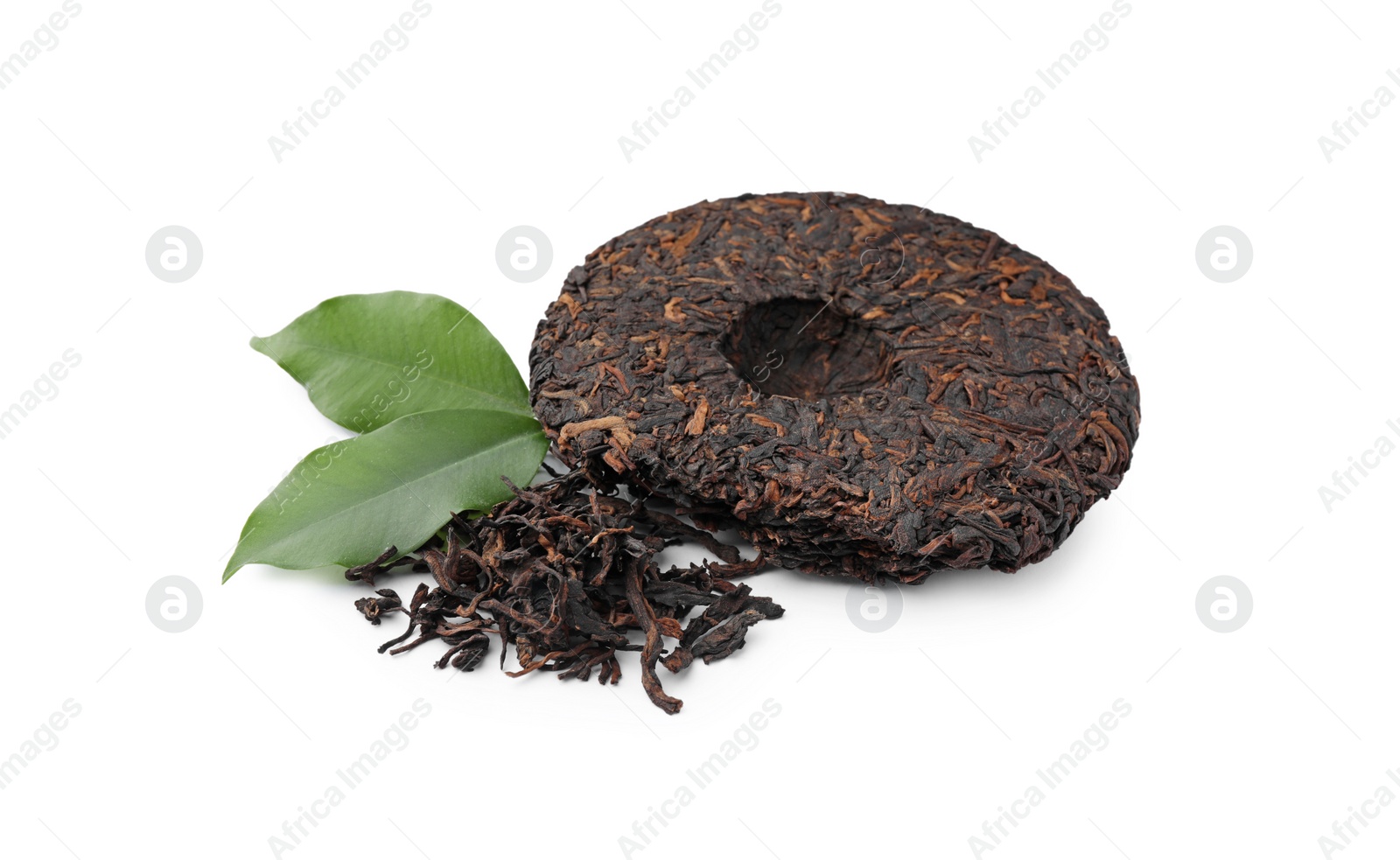 Photo of Broken disc shaped traditional Chinese pu-erh tea and fresh leaves isolated on white