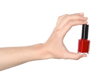 Woman holding nail polish on white background, closeup