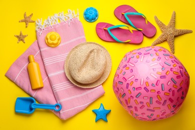 Photo of Flat lay composition with beach ball and sand toys on yellow background