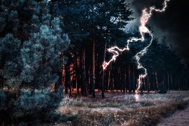 Image of Dark cloudy sky with lightning striking tree and ground. Thunderstorm