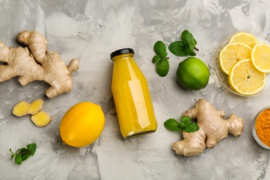 Photo of Flat lay composition with immunity boosting drink and ingredients on grey table