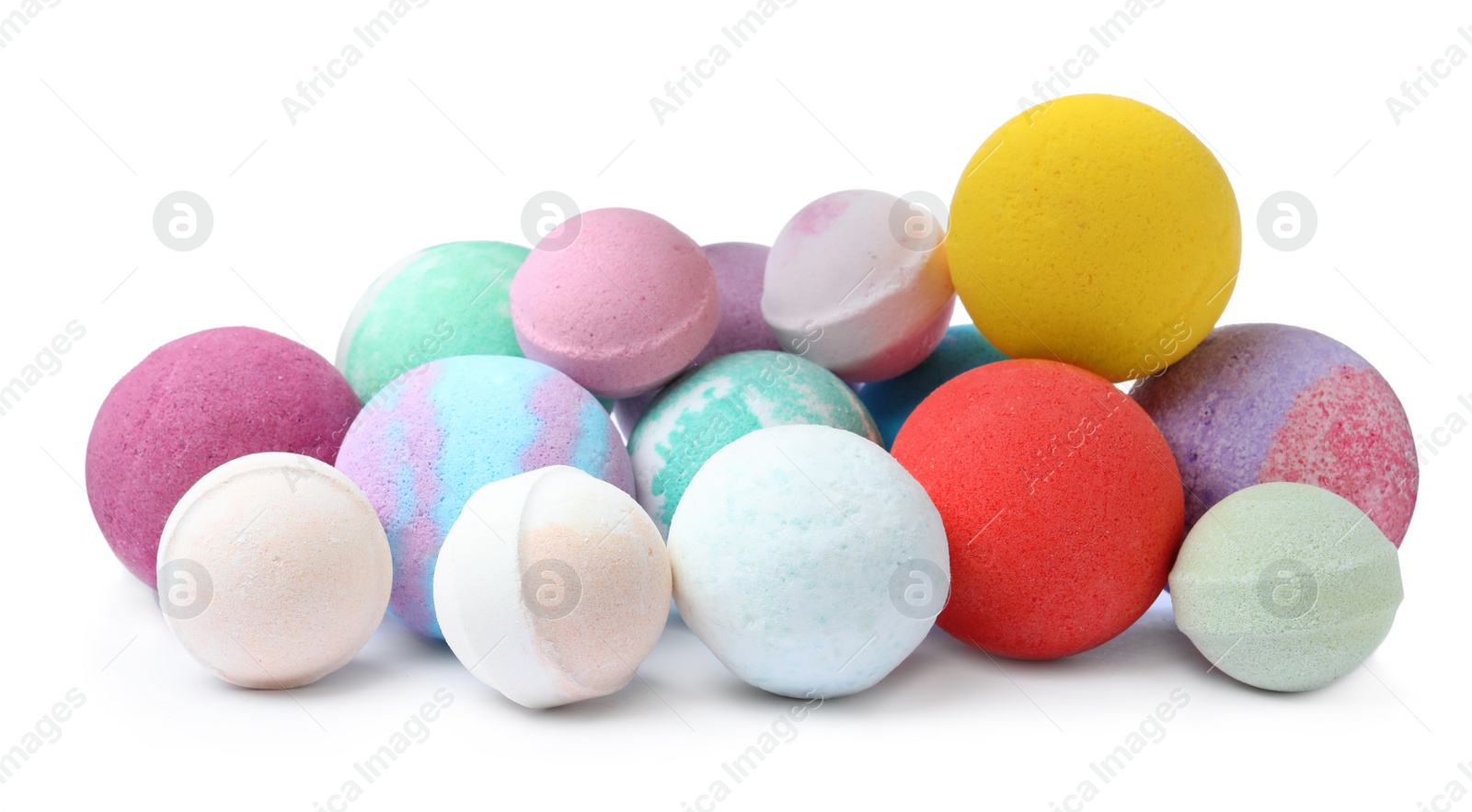 Photo of Many colorful bath bombs on white background