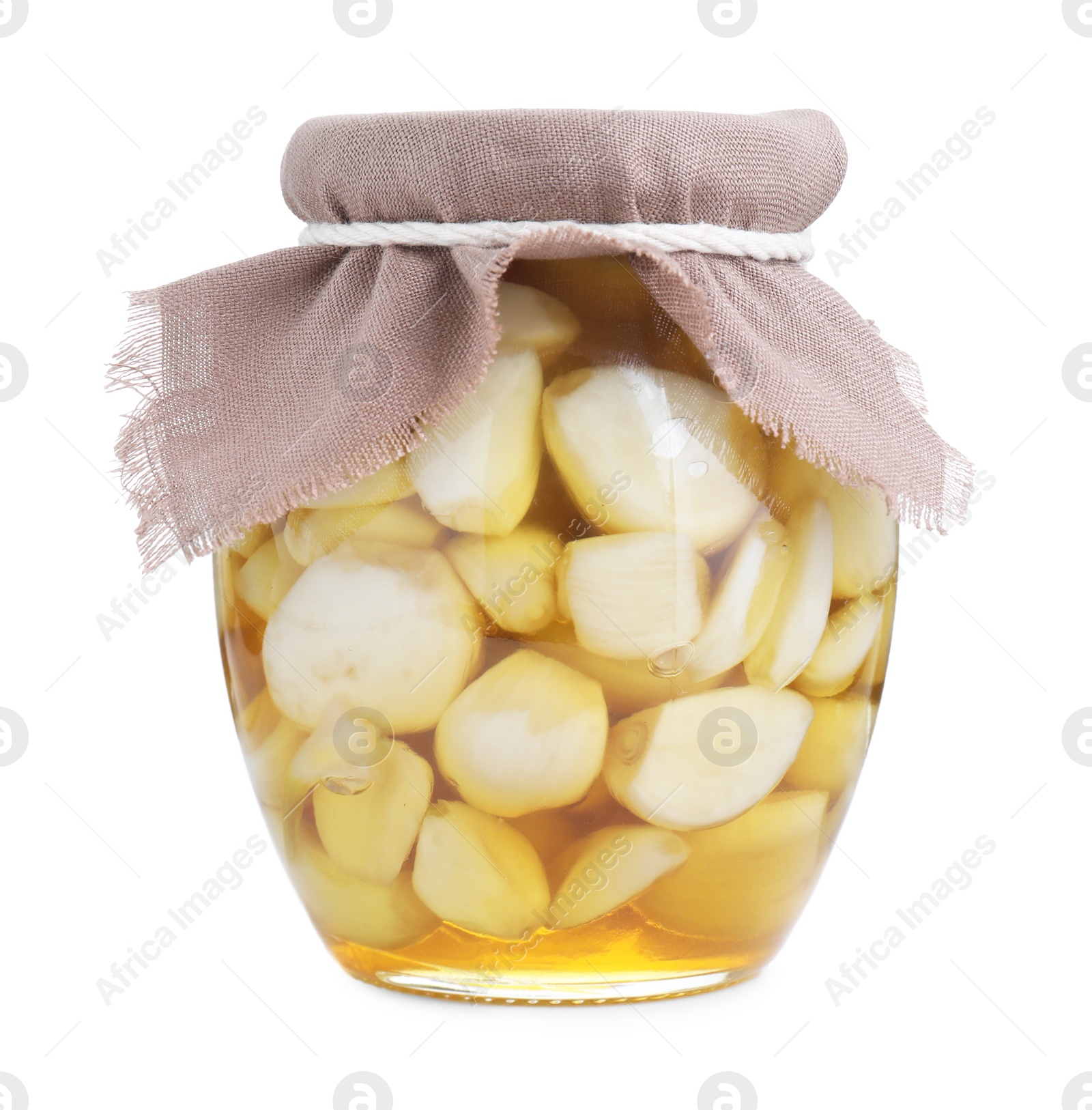 Photo of Garlic with honey in glass jar isolated on white