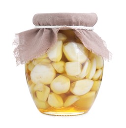 Garlic with honey in glass jar isolated on white