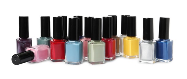 Bright nail polishes in bottles isolated on white