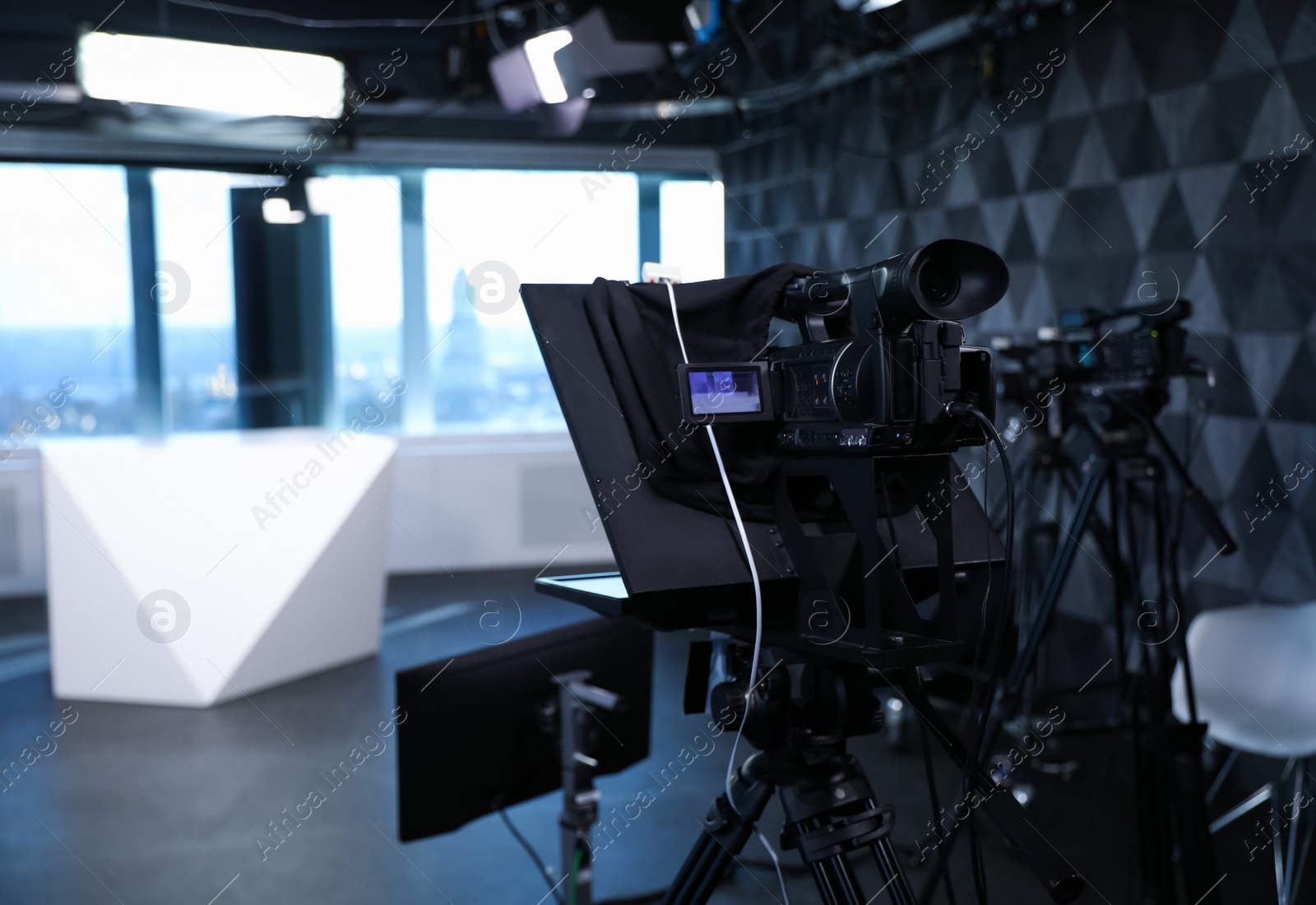 Photo of Modern video recording studio with professional equipment, focus on camera