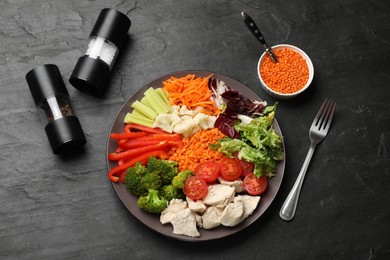 Photo of Balanced diet and healthy foods. Plate with different delicious products served on black table, top view