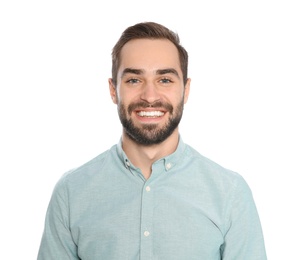 Portrait of young man laughing on white background