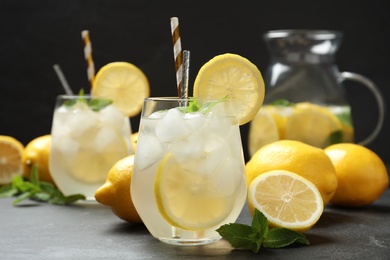 Photo of Natural lemonade with mint on grey table. Summer refreshing drink
