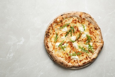 Image of Tasty cheese pizza on light marble table, top view. Space for text