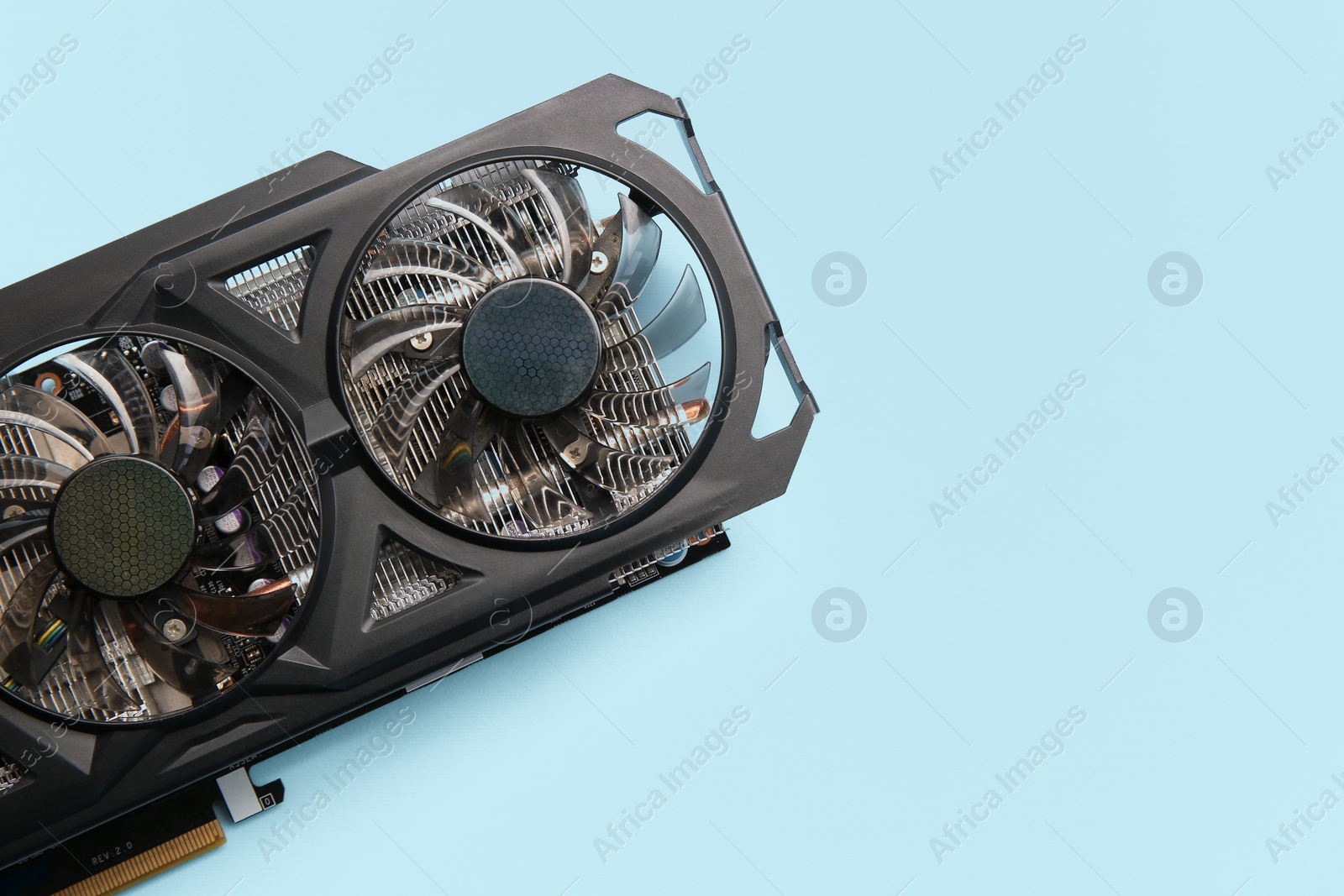 Photo of One graphics card on light blue background, top view. Space for text