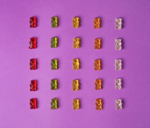 Photo of Flat lay composition with delicious jelly bears on color background