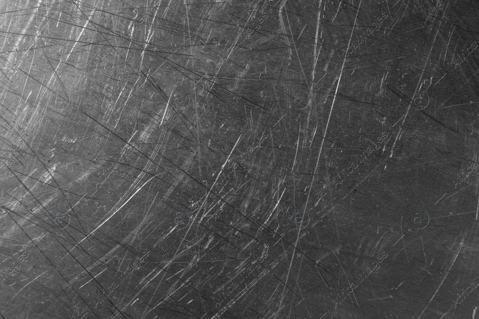 Photo of Texture of scratched metallic surface as background, closeup