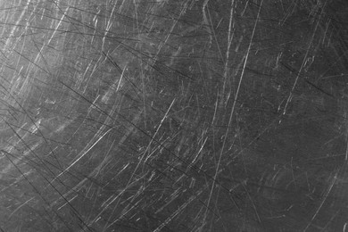 Texture of scratched metallic surface as background, closeup